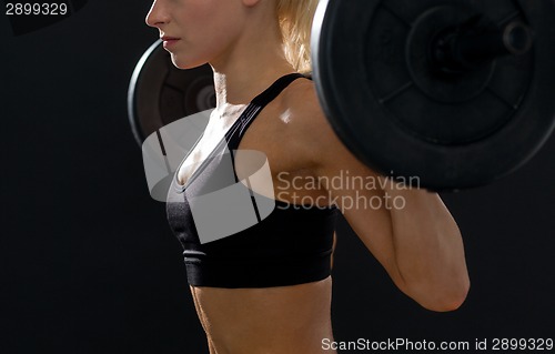 Image of sporty woman exercising with barbell