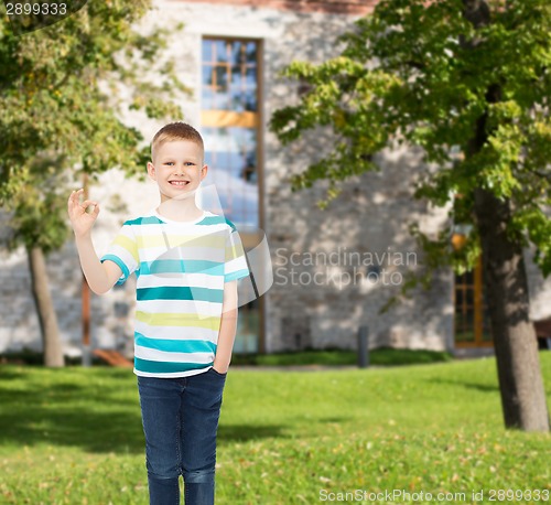 Image of smiling little boy showing ok sign