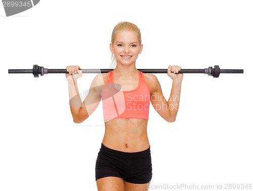 Image of smiling sporty woman exercising with barbell