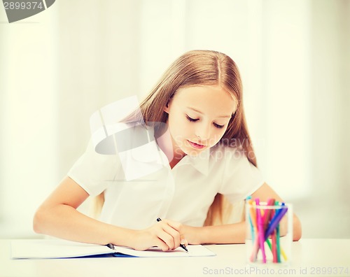 Image of little student girl drawing at school