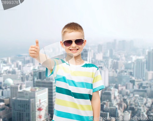 Image of smiling little boy over green background