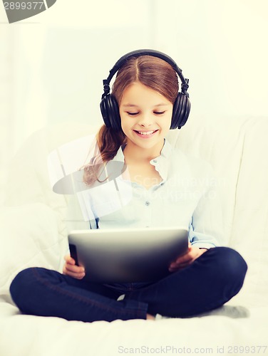 Image of girl with tablet pc and headphones at home
