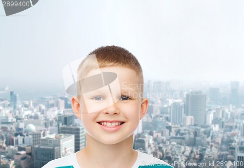 Image of smiling little boy over green background