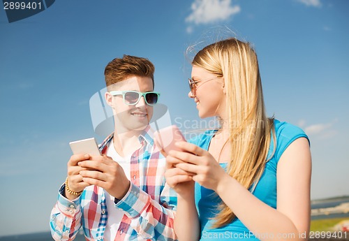 Image of smiling couple having fun outdoors