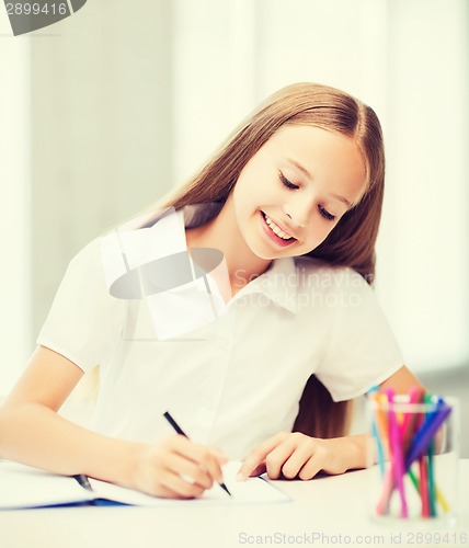 Image of little student girl drawing at school