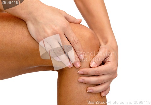 Image of close up of female hands holding knee