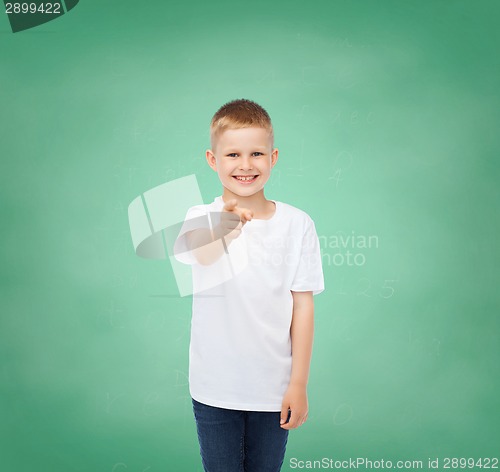 Image of little boy in white t-shirt pointing his finger