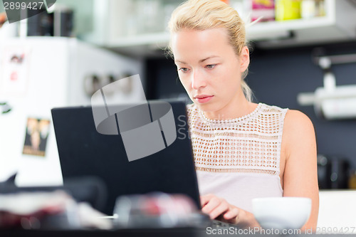 Image of Business woman working from home.