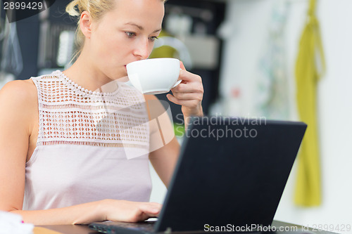 Image of Business woman working from home.