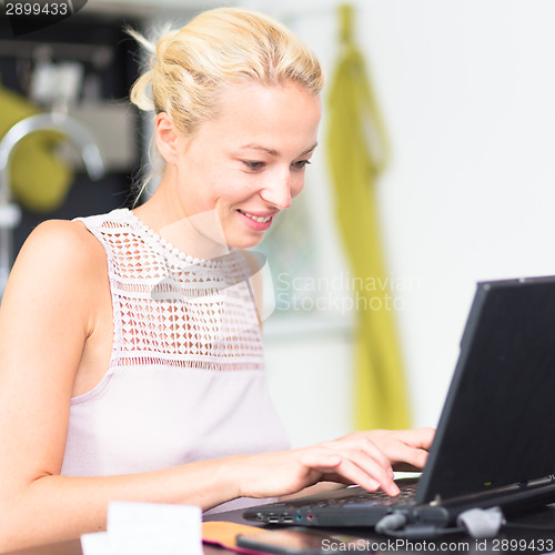 Image of Business woman working from home.