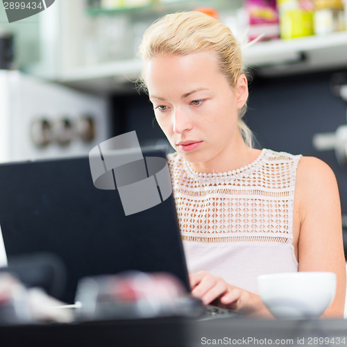 Image of Business woman working from home.