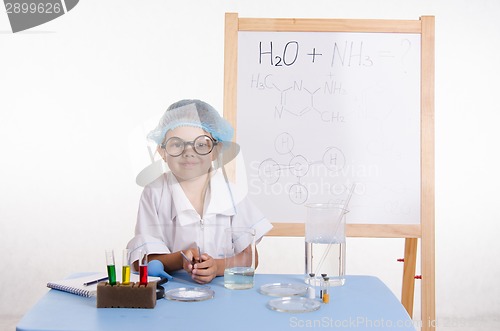 Image of Scientist chemist at table in the laboratory
