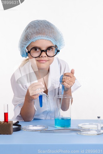 Image of Lab technician gaining pipetted liquid in a test tube