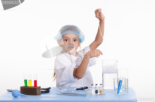 Image of Chemist adjusts air hose to the flask