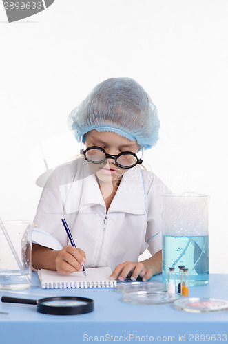 Image of Pharmacist writing in a notebook