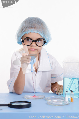 Image of Young serious chemist with a pipette