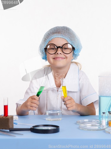 Image of Young chemist mixes the liquid