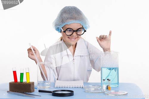 Image of Girl chemist rejoices successful experience
