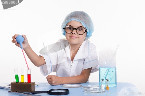 Image of Young Chemist gaining pipetted liquid from a test tube