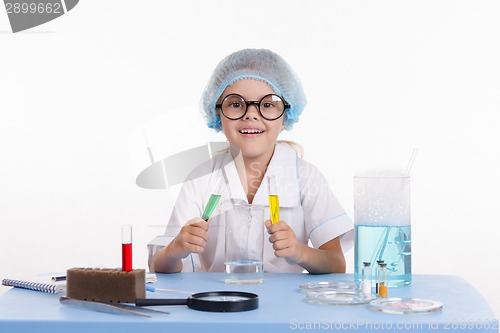 Image of Young chemist mixes the two liquids