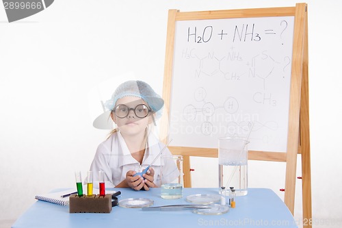 Image of Scientist chemist at the table