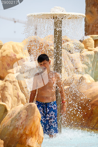 Image of boy in tunisian aquapark resort under shower