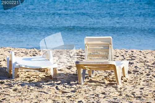 Image of two old sunloungers on tunisian beach