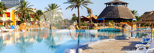 Image of sunloungers on swimming pool