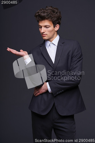 Image of Businessman showing something