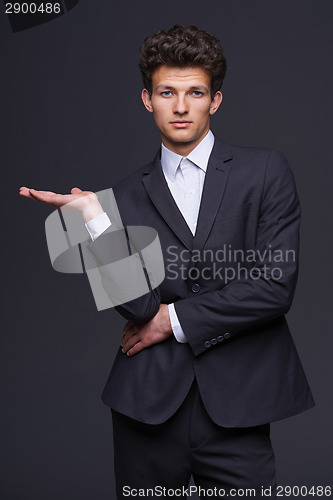 Image of Businessman showing something