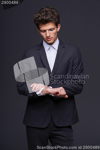 Image of Business man looking on his wrist