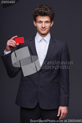 Image of Smiling business man showing blank credit card