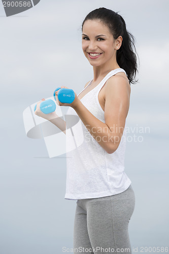 Image of Woman doing exercises with weights 