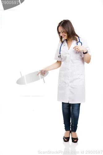 Image of Beautiful young veterinary looking down and pointing, isolated o
