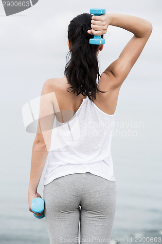 Image of Woman doing exercises with weights 