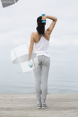 Image of Woman doing exercises with weights 