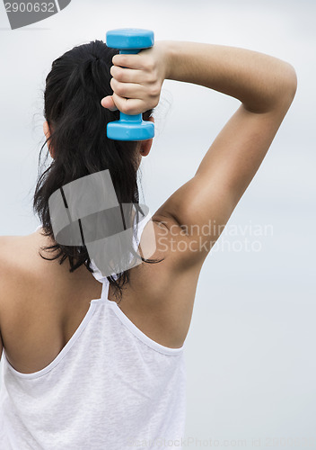 Image of Woman doing exercises with weights 