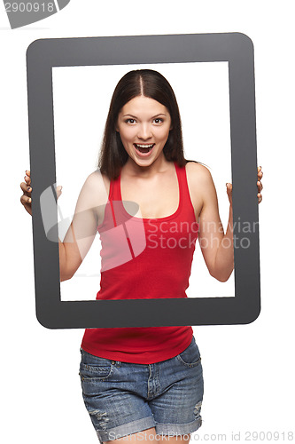 Image of Excited teen girl looking through frame,