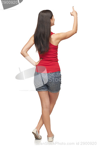 Image of Female in full length pointing at blank copy space