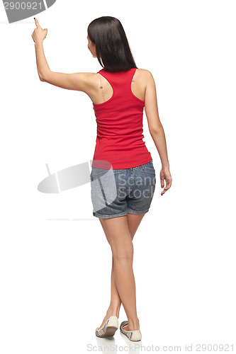 Image of Female in full length pointing at blank copy space