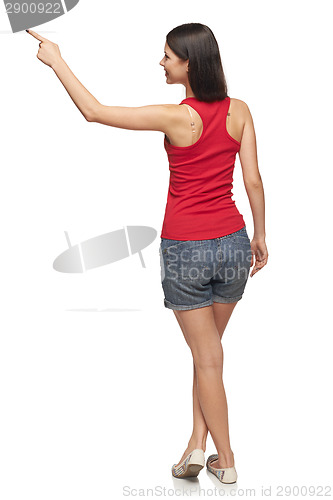 Image of Female in full length pointing at blank copy space