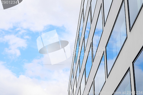Image of Blue sky and clouds reflected windows of modern building