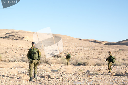 Image of Soldiers patrol in desert