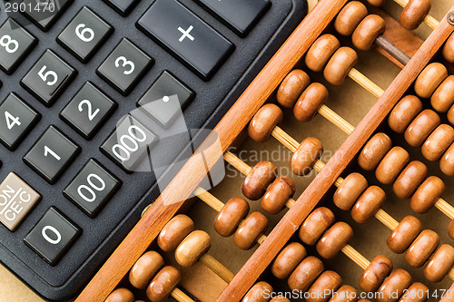 Image of Modern calculator and abacus 