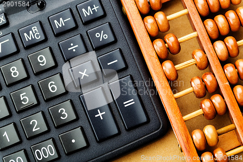 Image of Modern calculator and abacus