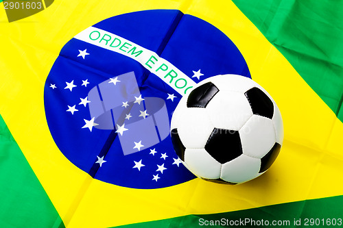 Image of Waved Brazilian flag and football