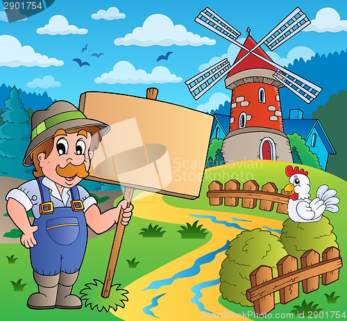 Image of Farmer with sign near windmill