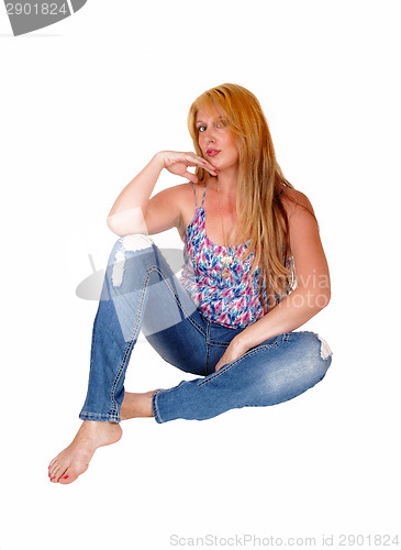Image of Woman sitting on floor.