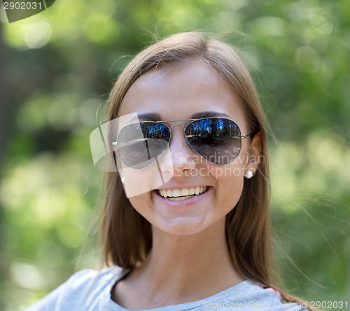 Image of portrait of a girl in sunglasses in the forest