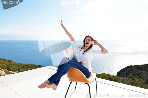 Image of relaxed young woman at home working on laptop